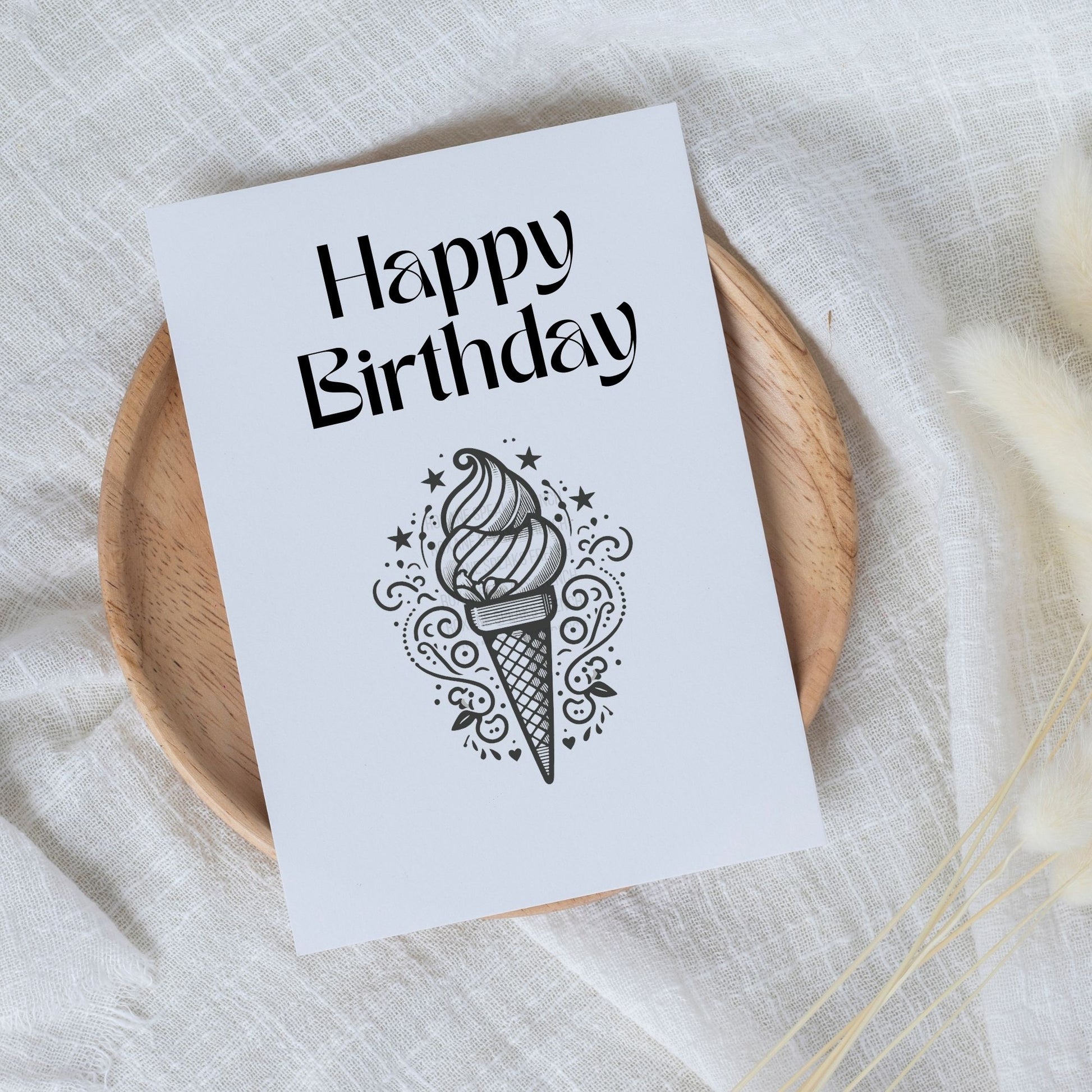 a birthday card with a clean and elegant design. The central graphic is a detailed ice cream cone with decorative elements such as stars and swirl patterns, rendered in a black and white silhouette style.